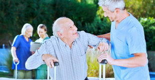 caregiver helping senior man